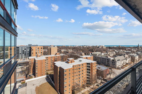 Panoramic view of urban buildings and distant horizon from a high vantage point.
