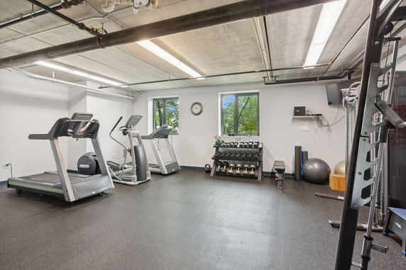 Room equipped with exercise machines and weights.