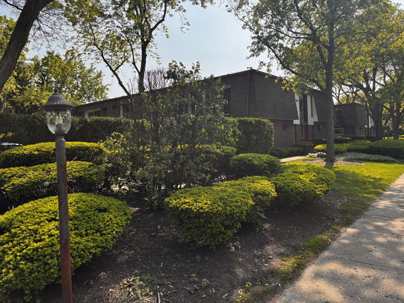 Front view of a two-story building with a flat roof and brick exterior.