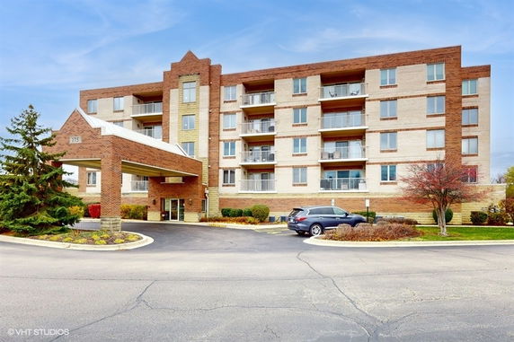 Front view of a multi-story residential building with a portico.