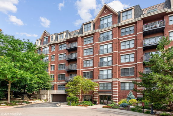 Front view of a multi-story apartment building with brick facade.