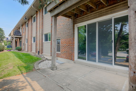 Front view of a two-story building with brick and siding exterior.