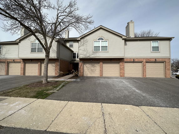 Front view of a two-story house with attached garages.