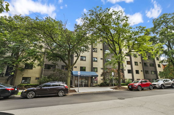Front view of a multi-story residential building with a canopy entrance.