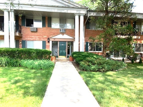 Front view of a two-story residential building with columns.