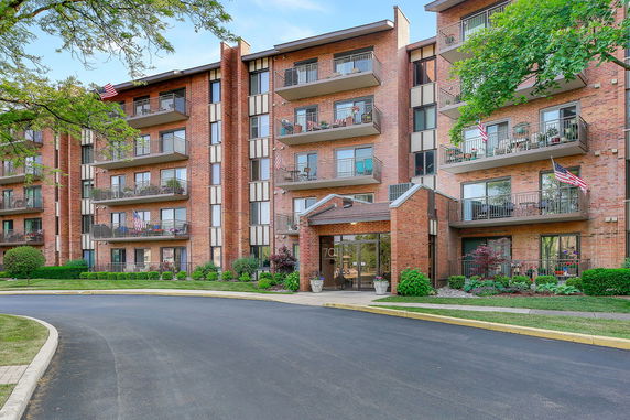 Front view of a multi-story residential building with balconies.