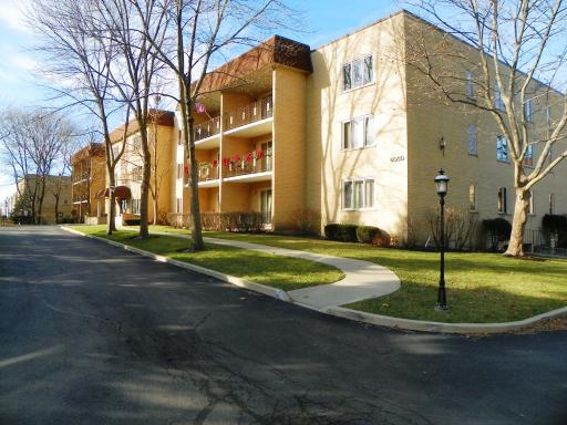 Front view of a three-story apartment building with balconies.