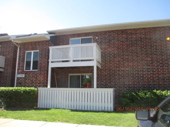Front view of a two-story brick building with balconies.
