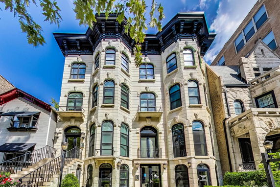 Front view of a multi-story historic building with ornate architecture.