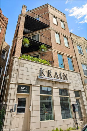 Front view of a multi-story commercial and residential building.