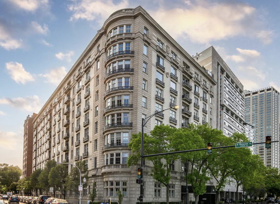 Front view of a multi-story residential building with ornate architecture.