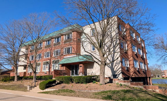 Front view of a multi-story brick apartment building.