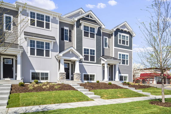 Front view of a multi-story townhouse with a modern design.