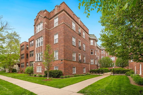Front view of a multi-story brick apartment building.