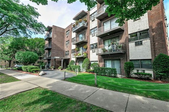 Front view of a multi-story residential building with balconies.