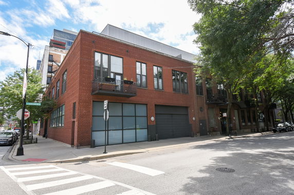 Front view of a two-story brick building on a corner street.