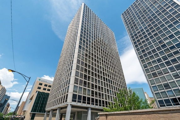 Front view of a modern high-rise building with a grid-like facade.
