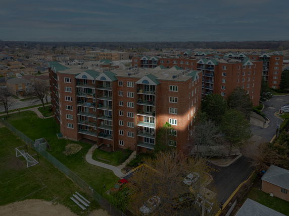 Front view of a multi-story residential building with balconies.