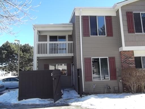 Front view of a two-story house with a small balcony and closed windows.