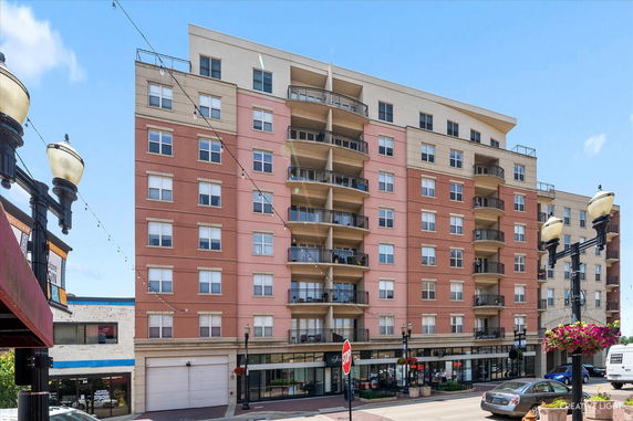 Front view of a multi-story residential building with balconies.