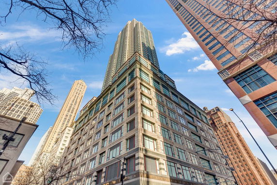 Front view of a tall multistory building with large windows.