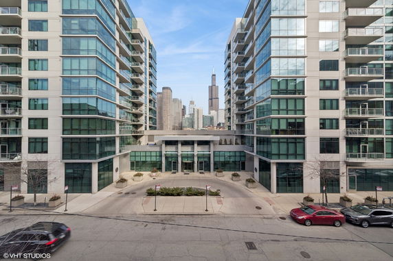 Front view of a modern multi-story building with glass windows.