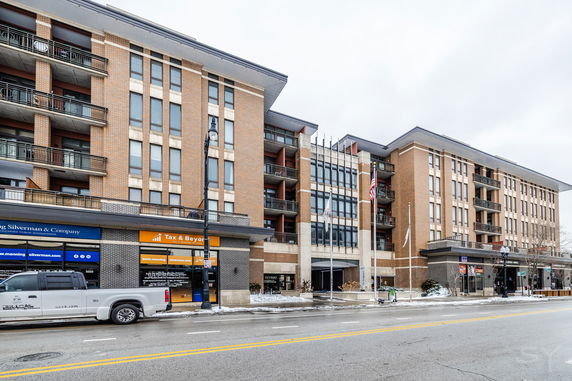 Front view of a multi-story commercial and residential building.