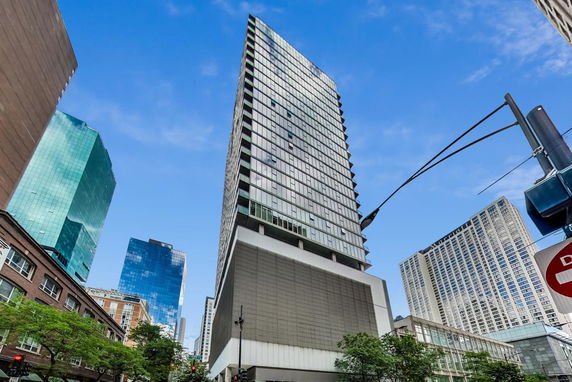 Front view of a modern high-rise building with glass facade.