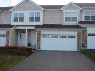 Front view of a two-story house with a double garage.