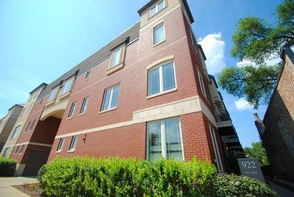 Front view of a multi-story brick building with multiple windows.