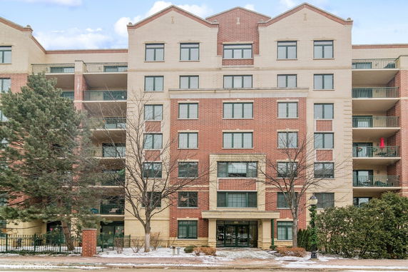 Front view of a multi-story residential building with balconies.