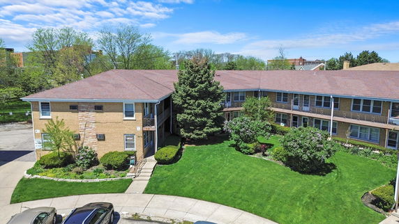 Front view of a two-story apartment building with a sloped roof.