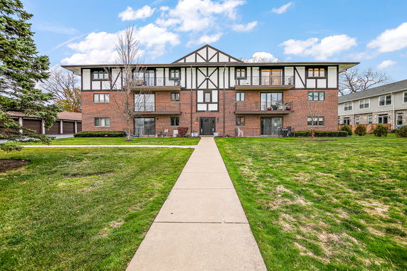Front view of a multi-story brick building with balconies.
