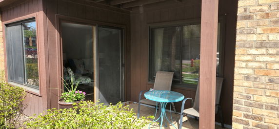 Partial view of a house with sliding glass doors and windows.