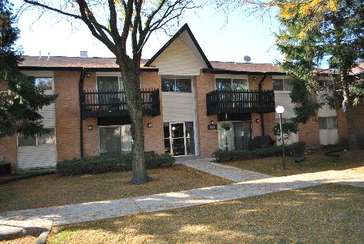 Front view of a two-story apartment building with balconies.