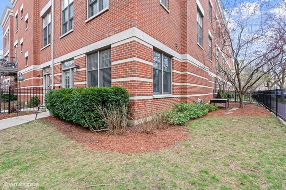 Corner view of a brick building with multiple windows.
