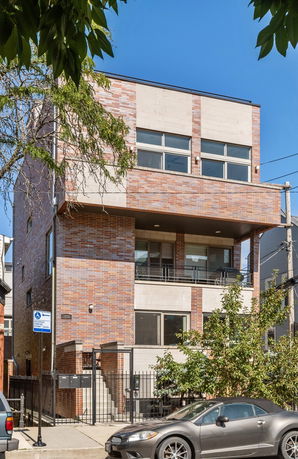 Front view of a modern three-story brick building.