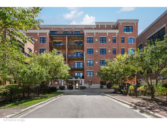 Front view of a multi-story brick apartment building.