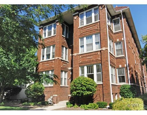 Front view of a multi-story red brick apartment building.