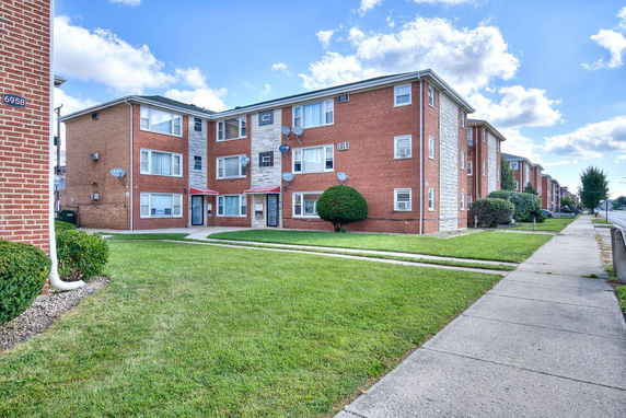 Front view of a three-story brick apartment building.
