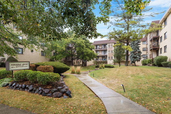 Front view of a multi-story residential building with balconies.