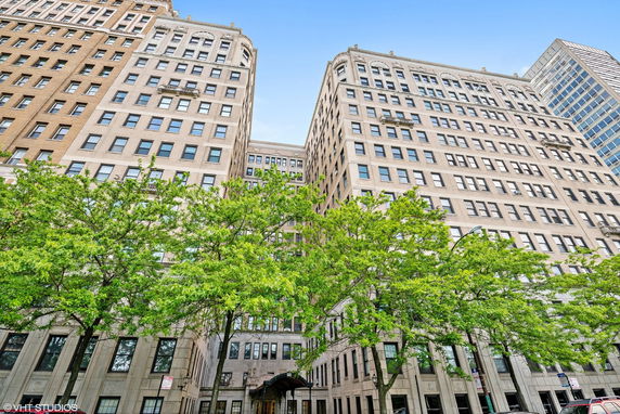 Front view of a multi-story building with numerous windows.