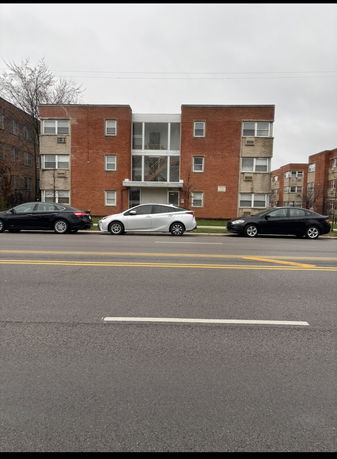 Front view of a three-story brick apartment building.