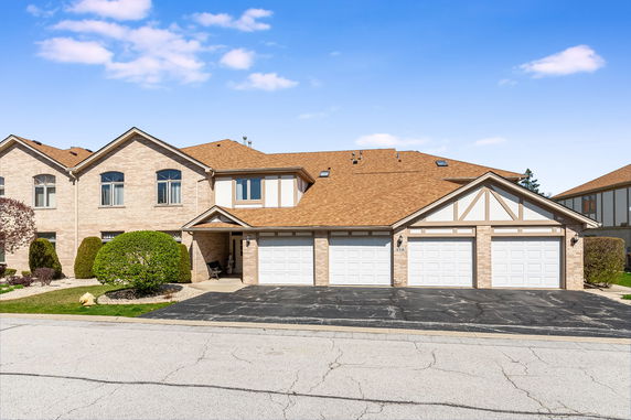 Front view of a multi-story house with a triple garage.