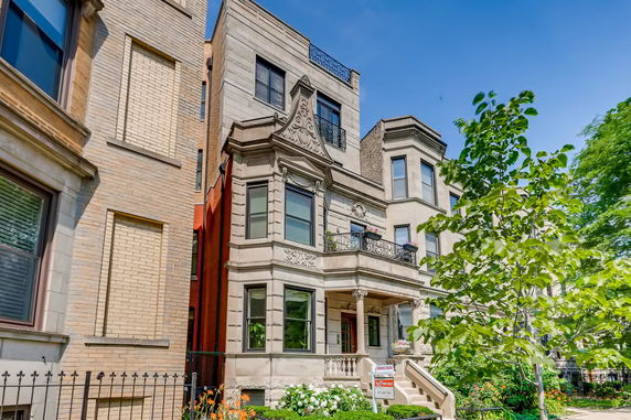 Front view of a multi-story house with ornate exterior details.
