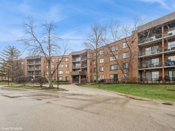 Front view of a multi-story brick apartment building.