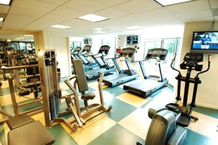 Indoor gym area with exercise equipment and treadmills.