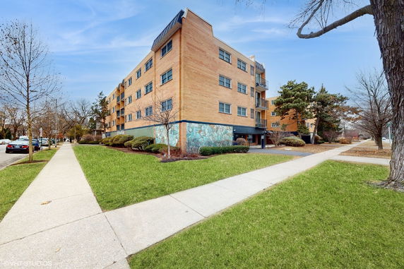 Front view of a multi-story brick apartment building.