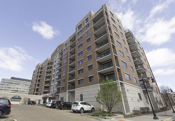 Front view of a multi-story apartment building with balconies.