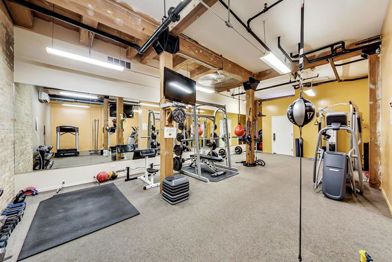 Indoor gym area with various exercise equipment.